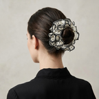 Hand-knitted black lattice scrunchie with white 3D petals by Tide Tie