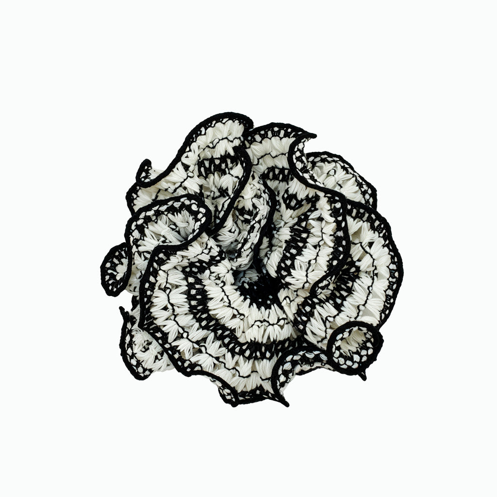 Hand-knitted black lattice scrunchie with white 3D petals by Tide Tie
